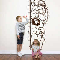 Height chart wall sticker with a pile of animals with a young boy and girl nearby.