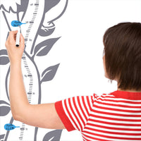 Height chart wall sticker of jack and the giant beanstalk with a mother charting the height of their child.