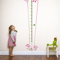 Height chart wall sticker of a kite being flown by a cat and dog with a young girl and kermit the frog nearby.