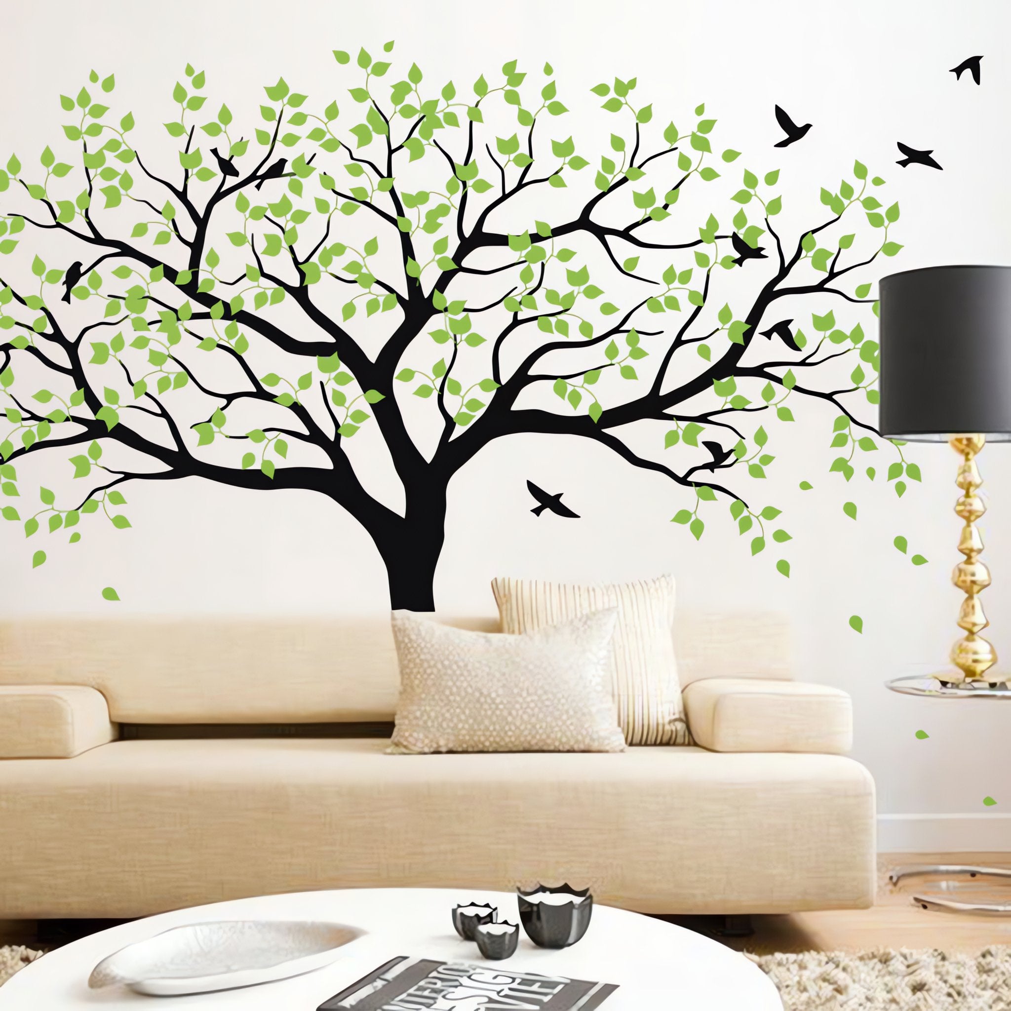 Large tree wall sticker with birds in a living room with a couch, coffee table and lamp.