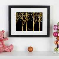 Personalized framed print with trees and family of birds with names next to pink cuddly toy and ball.