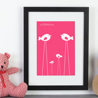 Personalised framed print with birds next to a pink teddy bear.