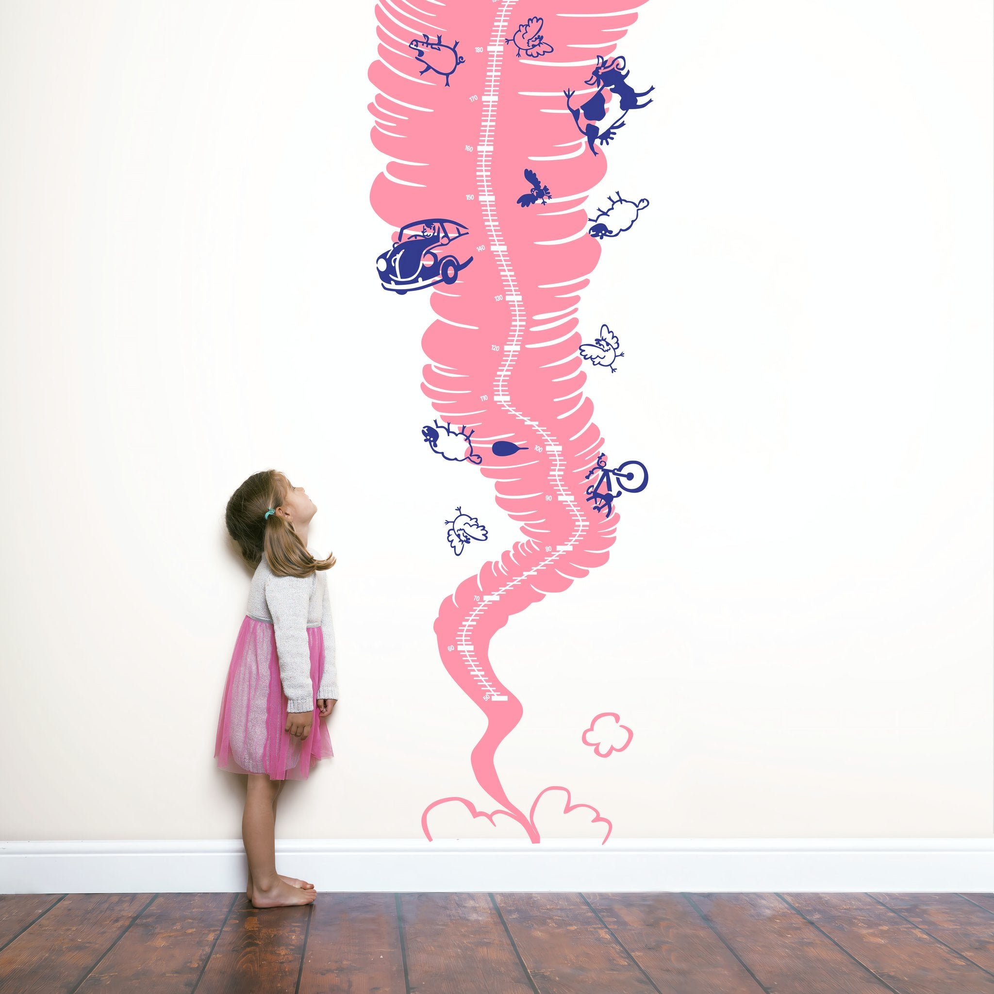 Height chart sticker of a tornado with a young girl nearby.
