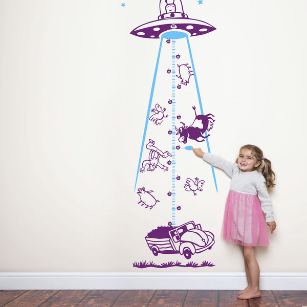 Height chart wall sticker of a UFO abducting a car with a young girl nearby.