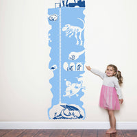 Height chart wall sticker of an underground mineshaft with a young girl pointing to her charted height.