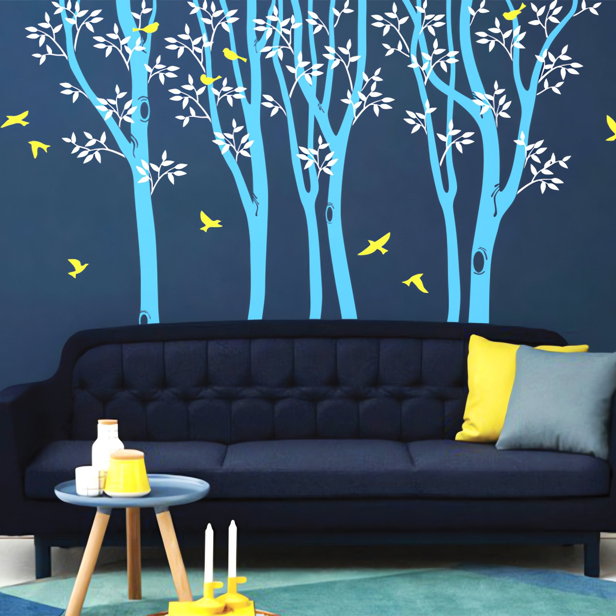 Tree wall sticker with trees and birds in a lounge with a long sofa.