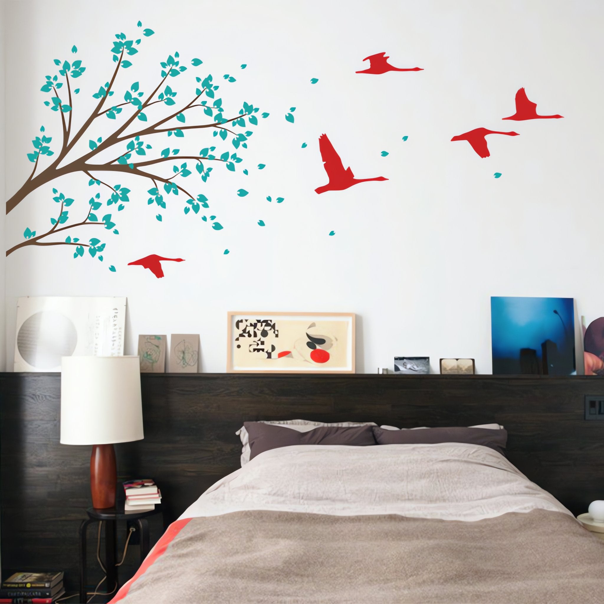 Tree wall sticker with overhanging branch and birds in an adult bedroom.