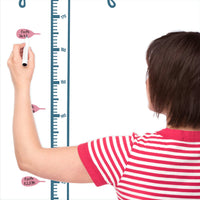 Height chart wall sticker of a cat bathed in light from a street lamp with a mother charting the height of their child.