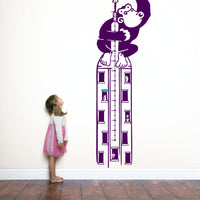 Height chart wall sticker of King Kong atop a sky scraper with a young girl nearby.