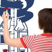 Height chart wall sticker of King Kong atop a sky scraper with a mother charting the height of their child.