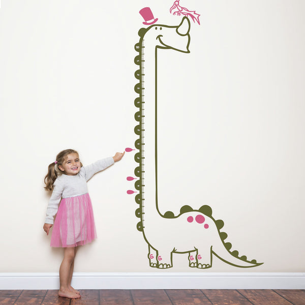 Height chart wall sticker of a long necked dianosaur with a young girl nearby.