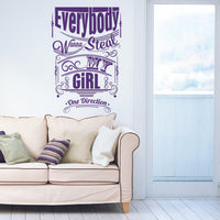 Wall quote sticker with text "Everybody Wanna Steal My Girl" by One Direction in a living room next to a window and a couch.