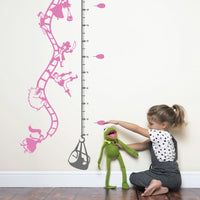 Height chart wall sticker of a hot air balloon taking off, a young girl nearby with a young girl playing with kermit the frog.