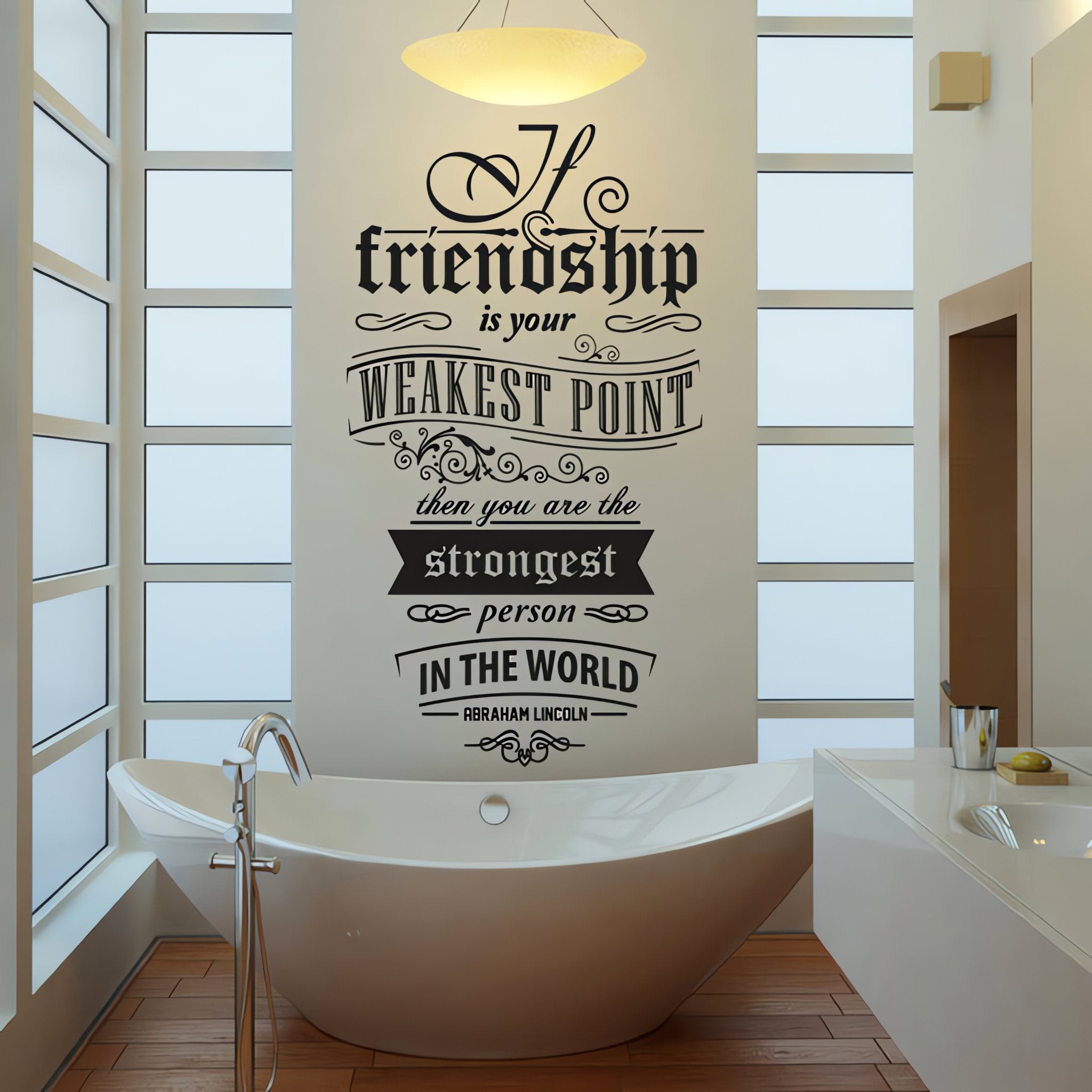 Wall quote sticker with text "If Friendship Is Your Weakest Point Then You Are The Strongest Person In The World" in a bathroom above a bathtub.
