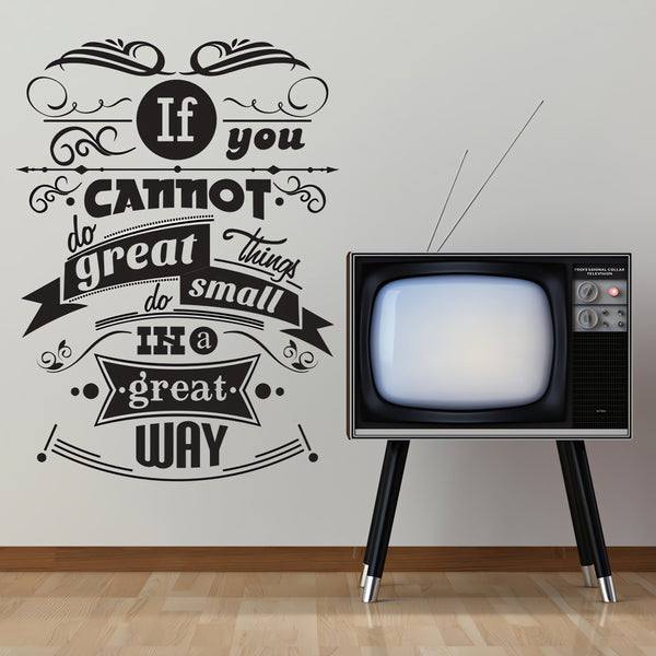 Wall quote sticker with text "You Cannot Do Great Things Do Small Things In A Great Way" next to a TV set.
