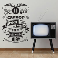 Wall quote sticker with text "You Cannot Do Great Things Do Small Things In A Great Way" next to a TV set.