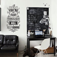 Wall quote sticker with text "You Only Live Once But If You Do It Right Once Is Enough" in a living room with leather seating, a table and a chair.