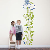 Height chart wall sticker of jack and the giant beanstalk with a young boy and girl nearby.