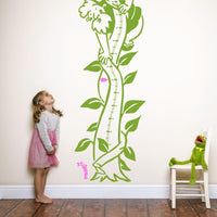 Height chart wall sticker of jack and the giant beanstalk with a young girl and kermit the frog nearby.