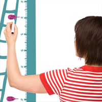 Height chart wall sticker of a kitten being rescued from a tree with a mother charting the height of their child.
