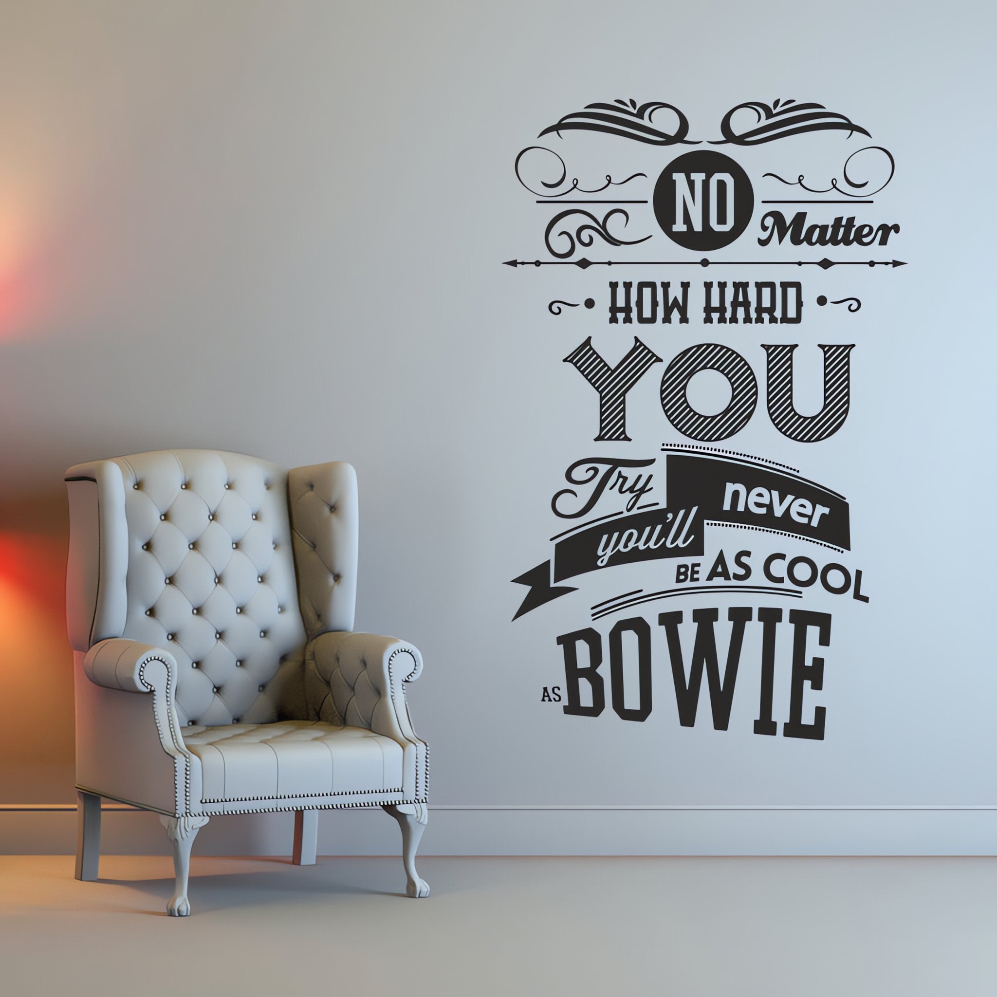 Wall quote sticker with text "No Matter How Hard You Try You'll Never Be As Cool As Bowie" next to a padded arm chair.