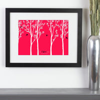 Personalized framed print with trees and family of birds with names next to vase.