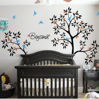 Tree wall sticker with 2 trees, birds and a name in a bedroom above a bed.
