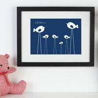 Personalised framed print with birds next to a pink teddy bear.