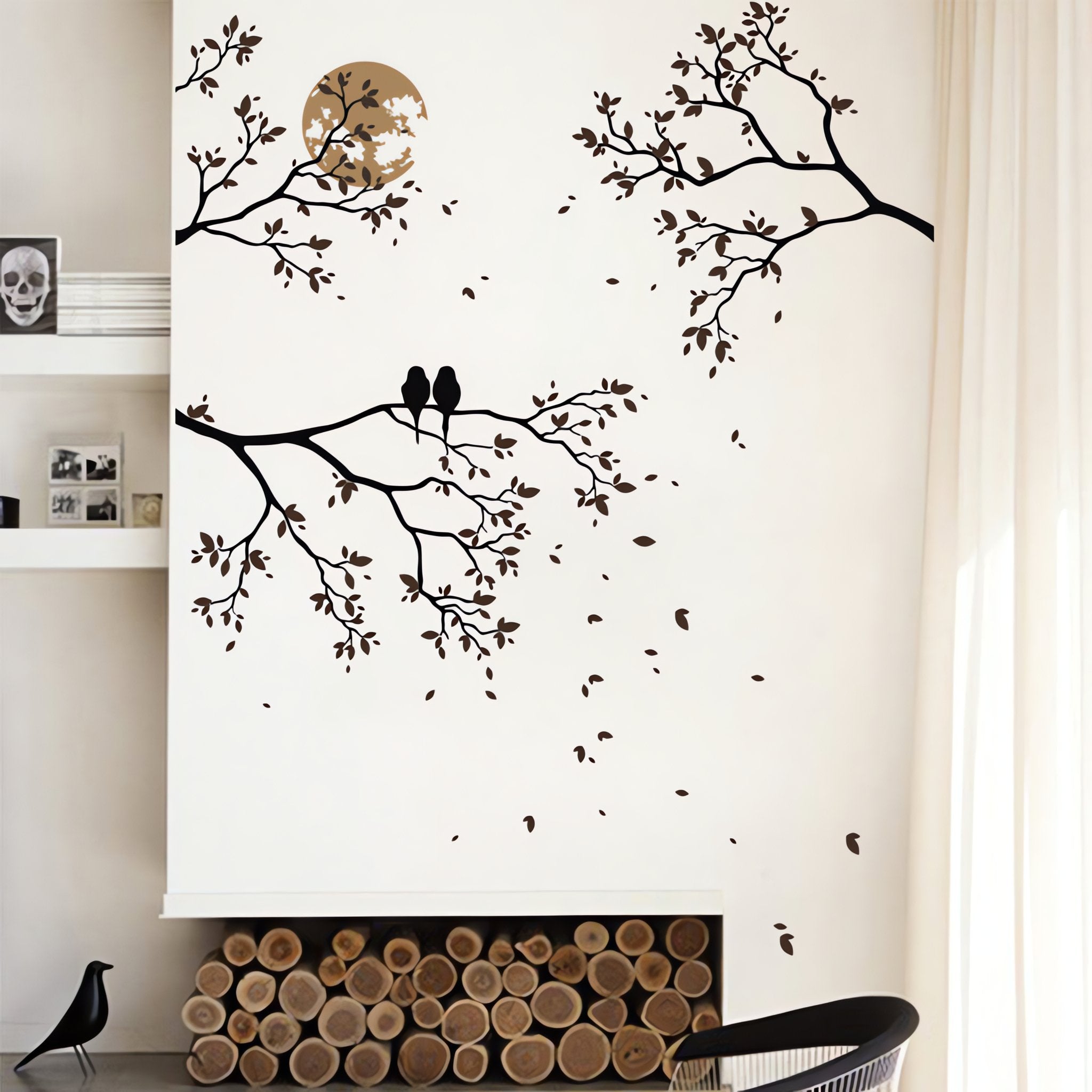 Tree wall sticker of 3 branches with 2 birds and the moon on a wall above some seating.