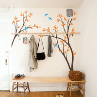 Tree wall sticker with birds and leafy branches in a cloak room.
