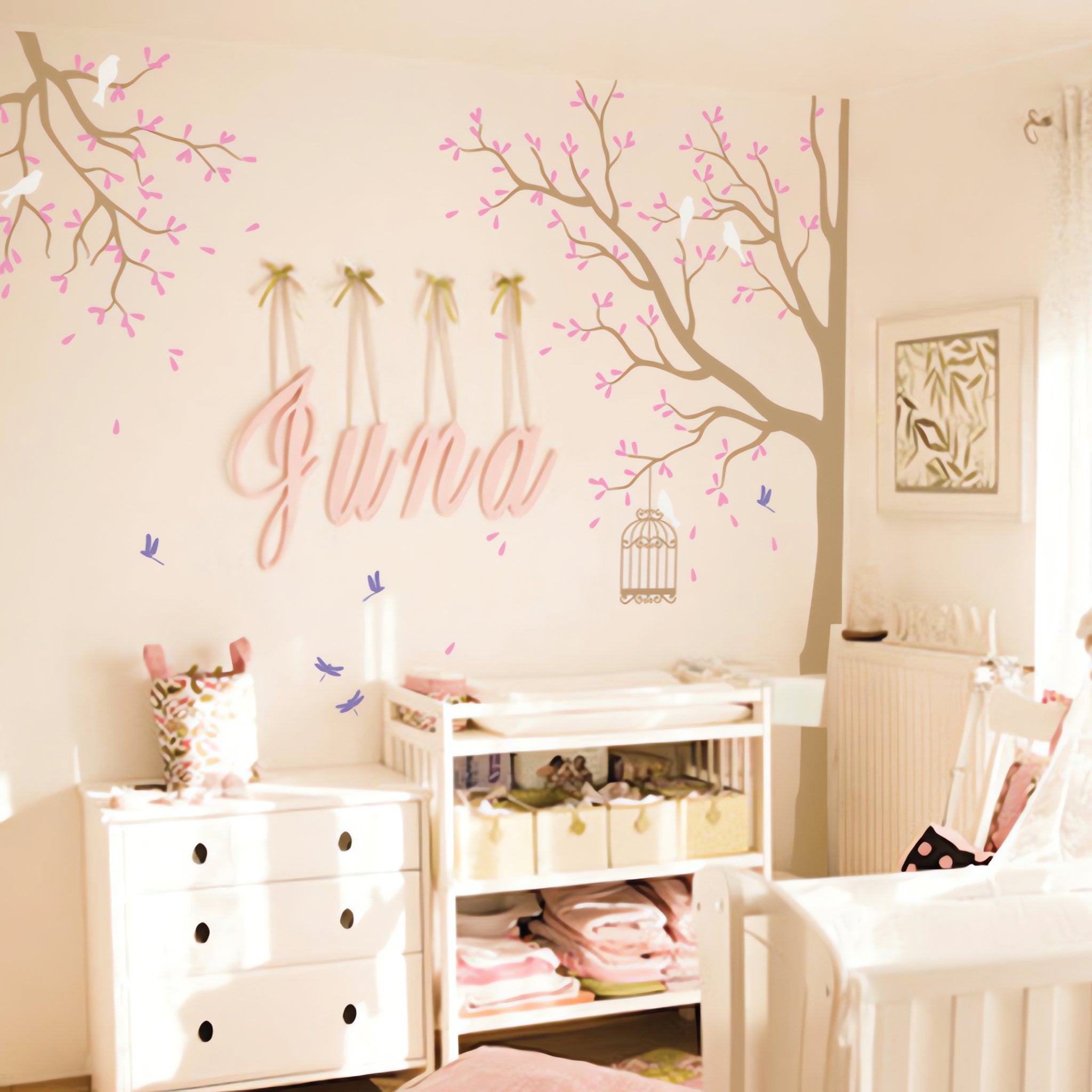 Tree wall sticker withbirds and dragonflies in a bright room with chairs and furniture.
