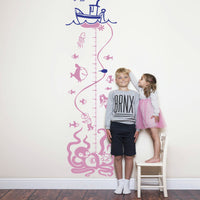 Height chart wall sticker with a boat and undersea monsters beneath the surface with a young boy and girl nearby.