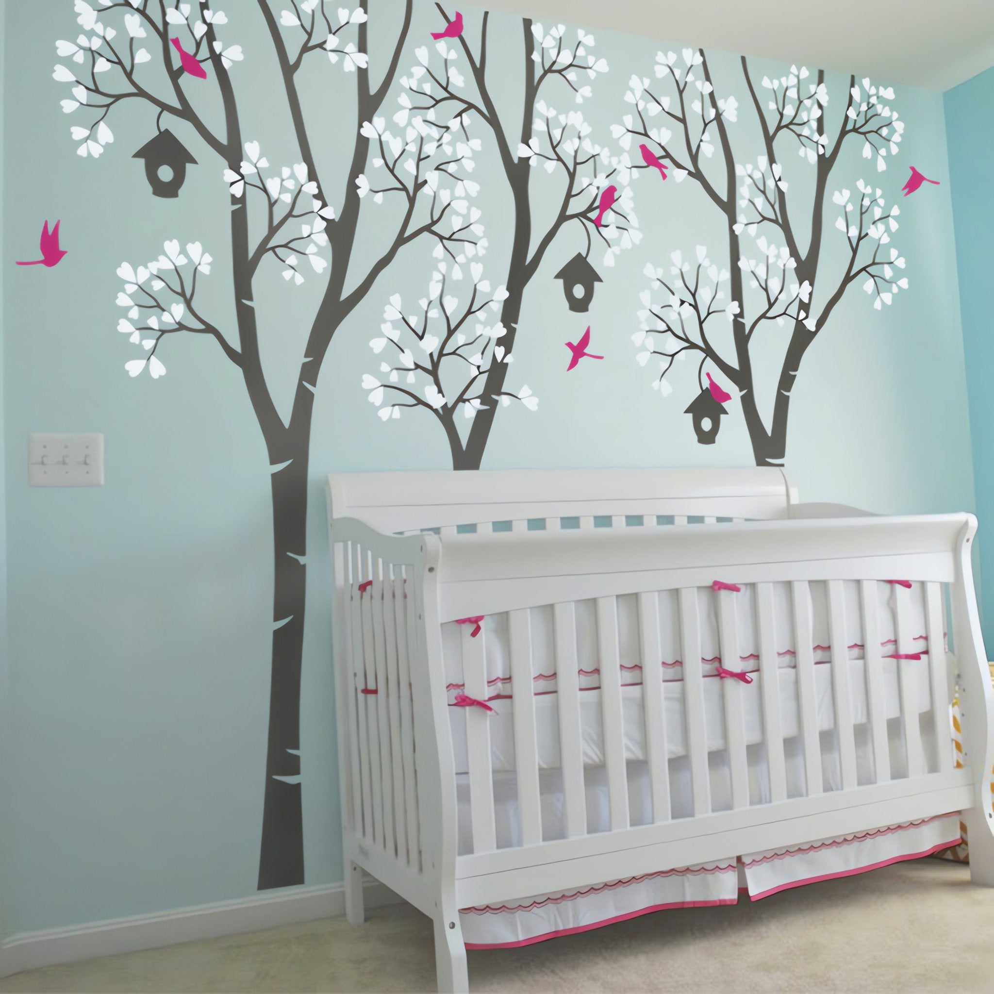 Tree wall sticker with birdhouses and birds in a nursery with a crib.