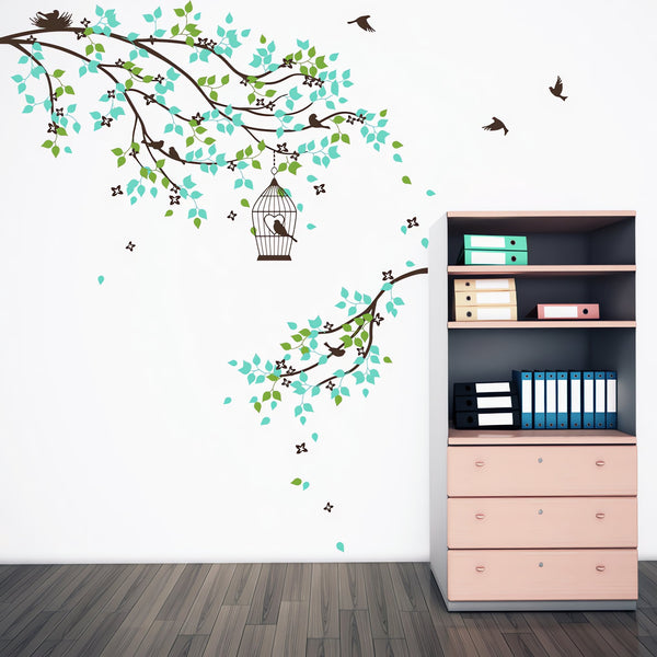 Tree wall sticker of 2 hanging branches with birds in a room with a shelf.