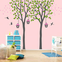 Tree wall sticker with birds and haning birdhouses in a nursery with a crib.