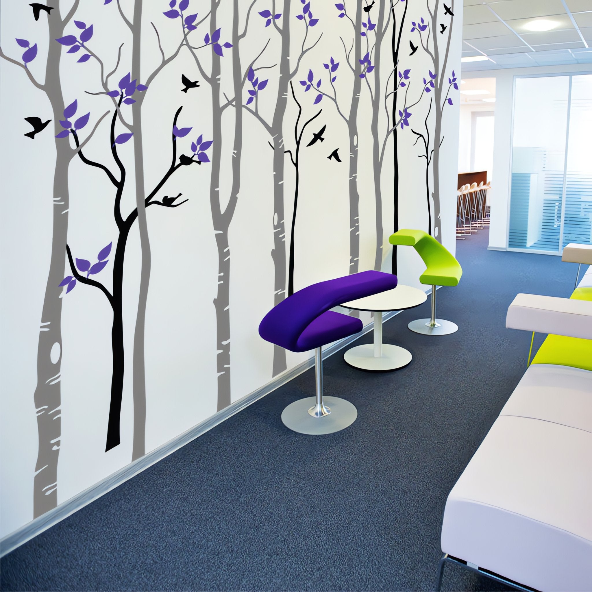 Tree wall sticker of many trees and birds in a modern room with bar stools.
