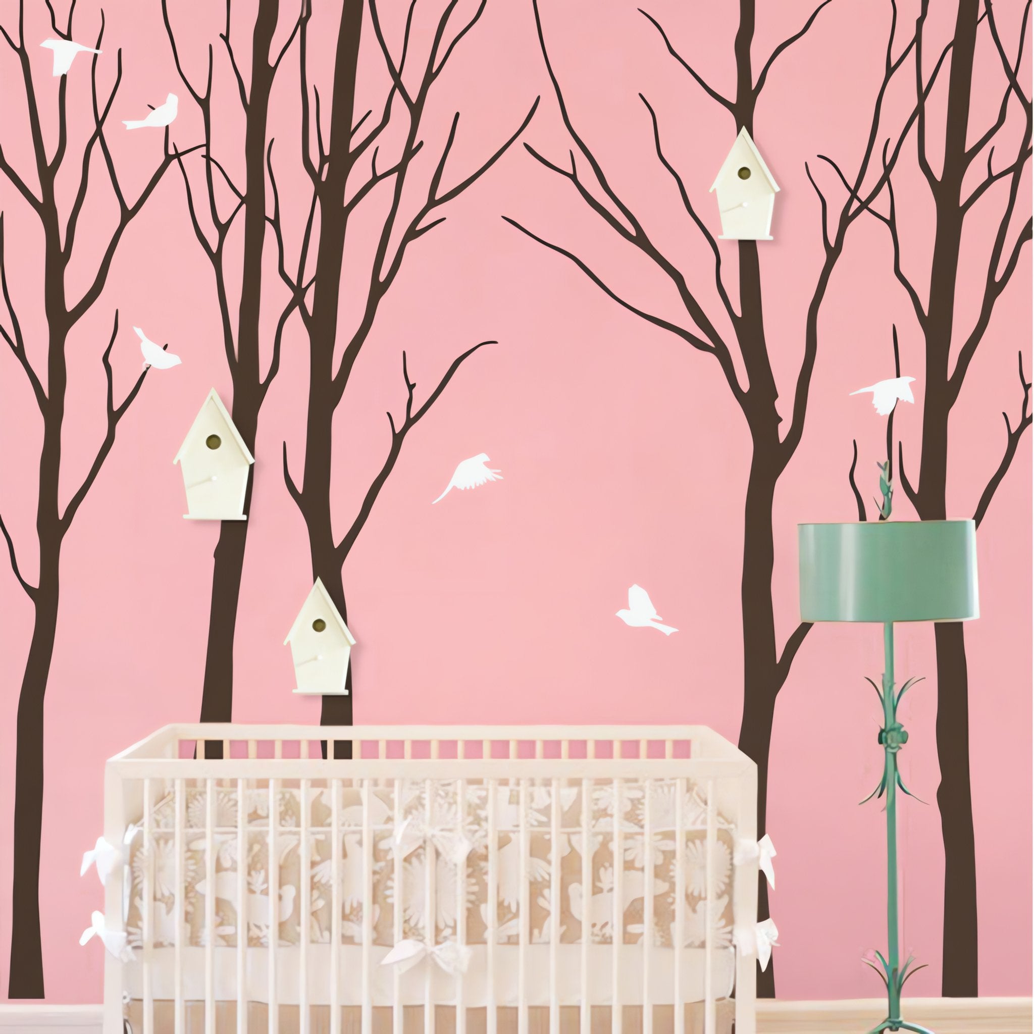 Tree wall sticker with birds and birdhouses in a nursery with a crib and a floorlamp.