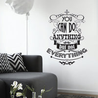 Wall quote sticker with text "You Can Do Anything But Not Everything" in a room with a seating area.